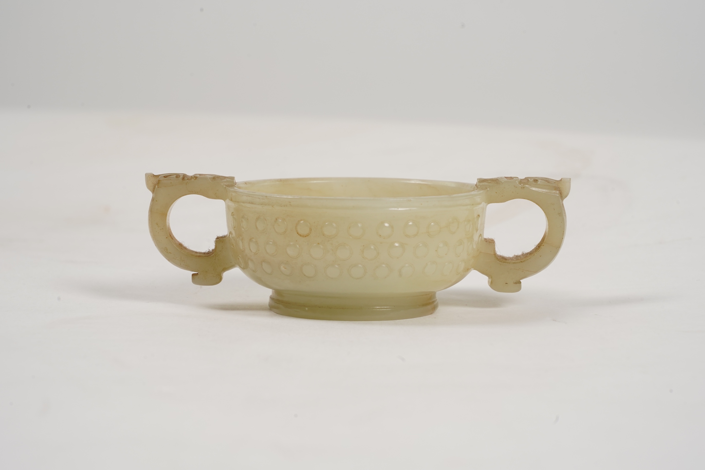 A Chinese pale celadon and russet veined jade cup, 17th century